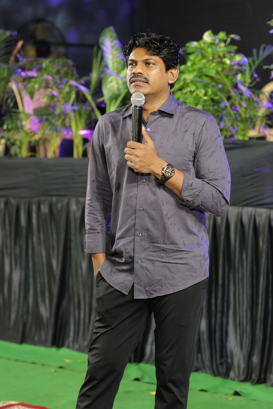 Bro. Smiles preaching on stage
