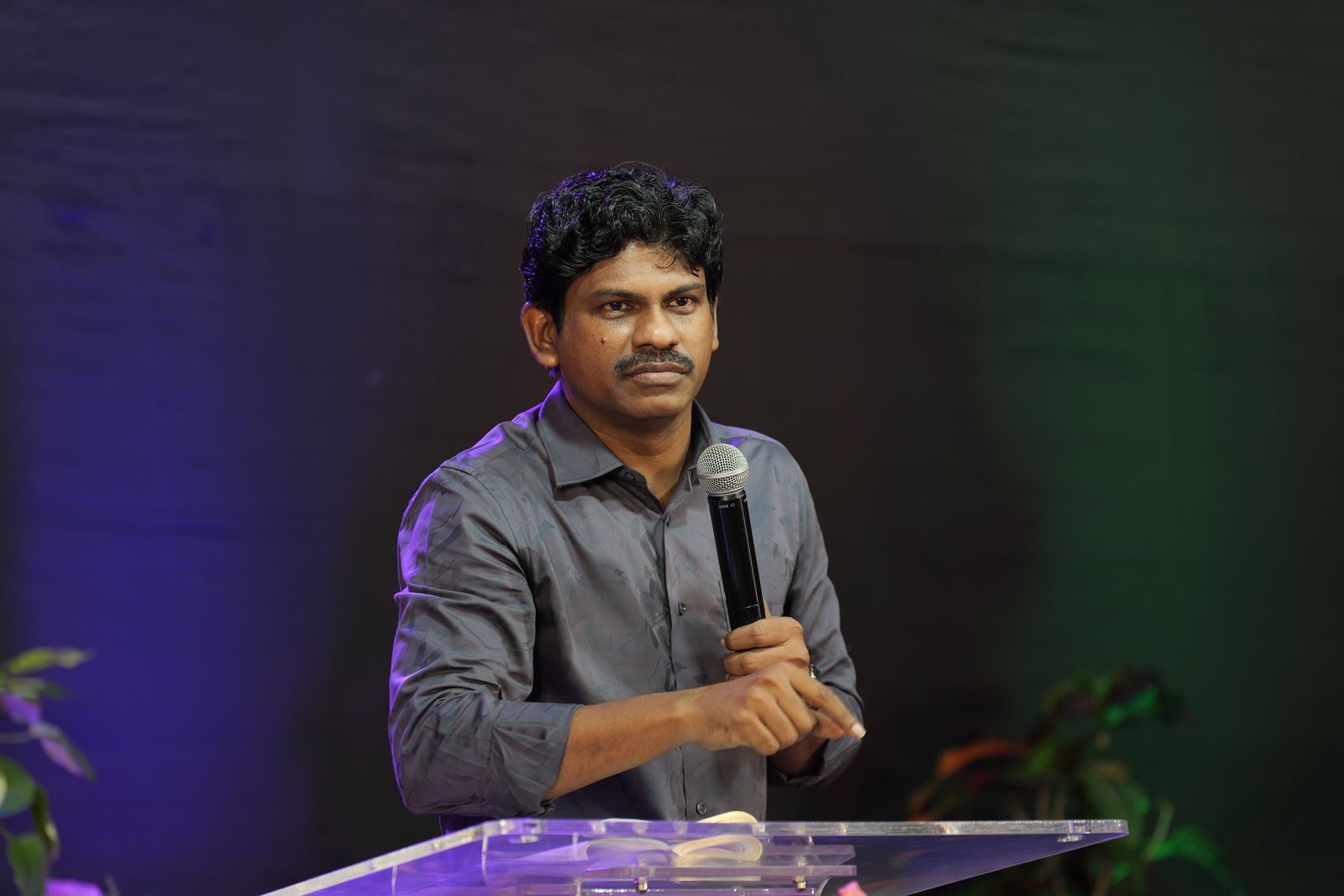 Bro. Smiles ministering at the podium