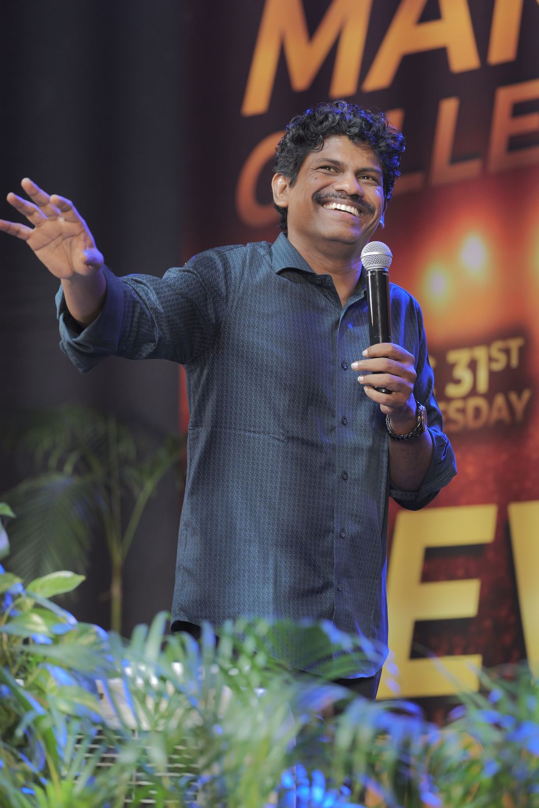Bro. Smiles worshipping with a raised hand